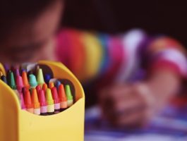 child with colouring pencils